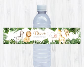May include: Water bottle label with a jungle theme. The label features a zebra, lion, elephant, giraffe, and monkey. The text on the label reads "Nico's First Birthday".
