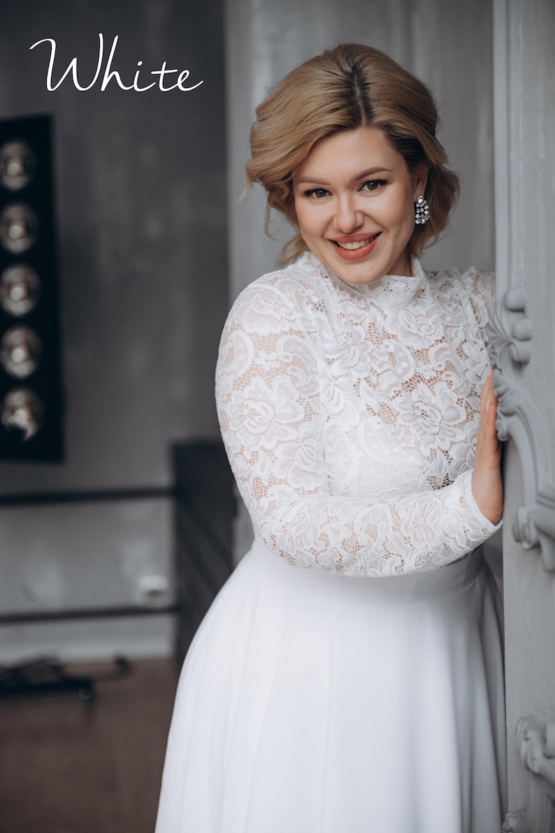 White lace long sleeve bridal blouse paired with satin skirt, classic wedding style.