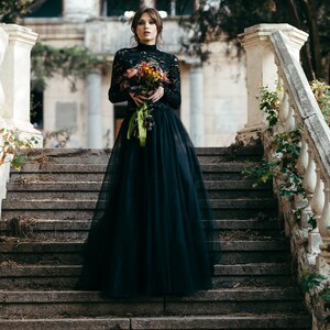 Black lace high neck bridal topper with full tulle skirt, gothic wedding style.