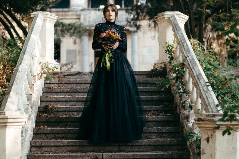Black lace high neck bridal topper with full tulle skirt, gothic wedding style.