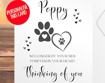 May include: A white greeting card with the name "Poppy" in elegant script. The card features paw prints, hearts, and the phrases "No Longer By Your Side Forever In Your Heart" and "Thinking of you." A red circle says "Personalise This Card."