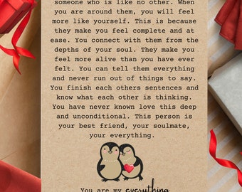 May include: A greeting card with a brown background features a heartfelt message about love and connection. Two cartoon penguins holding a heart are at the bottom. The words "You are my everything" are written below the penguins.