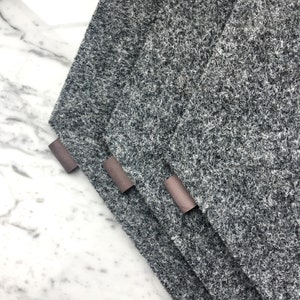 May include: Three gray felt cleaning cloths with brown leather tabs.
