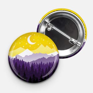 May include: A round button with a yellow and purple mountain landscape design. The mountains are silhouetted against a yellow sky with a crescent moon and stars. The button has a silver back with a pin.