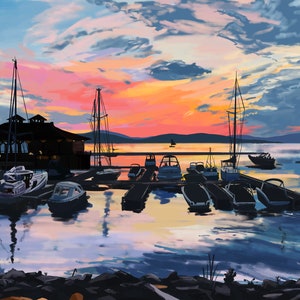 May include: A scenic sunset over a lake with a marina filled with boats. The sky is a mix of pink, orange, and blue with fluffy clouds. The boats are docked at a wooden pier with a building in the background.