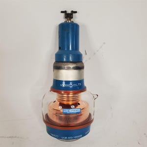May include: A clear glass capacitor with a copper housing and a blue ceramic top. The capacitor is labelled "10,000 VOLTS" and "Jennings" with the model number "UCSF-500-10N528".