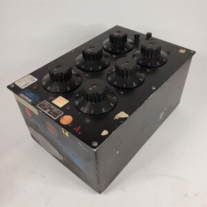 May include: A black metal box with six round knobs, each with numbers 0 to 3. The box has a label that reads "Leeds & Northrup Co."