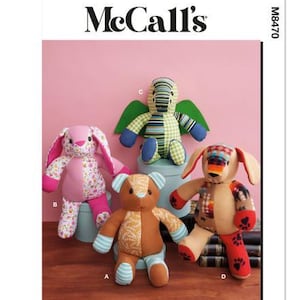 May include: A McCall's pattern showing four soft toy designs: a rabbit, a bear, a dragon, and a dog. The toys are made from patterned fabrics in pink, brown, green, and blue. The pattern is designed and printed in the USA.