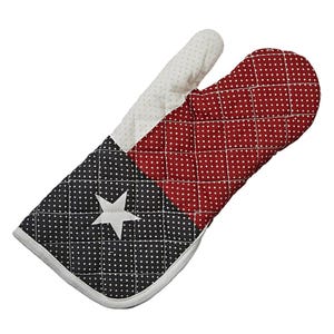 May include: Quilted oven mitt featuring a star and dot pattern in red, black, and white. The mitt has a white star on a black background, a red section with white dots, and a white cuff and thumb. The design is reminiscent of a flag.