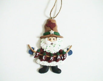 Texas Christmas Ornament - Santa holding a Texas Banner