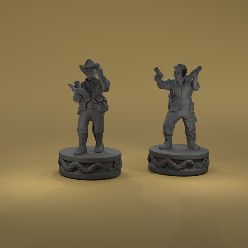 May include: Two gray painted miniature figures of people standing on round bases with a snake design. The figure on the left is wearing a hat and holding a book and a gun. The figure on the right is holding a gun in each hand.