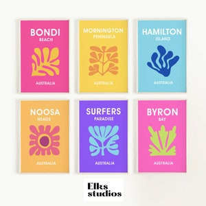 May include: Six colorful framed prints with abstract designs and text. The prints feature Australian locations like Bondi Beach, Mornington Peninsula, Hamilton Island, Noosa Heads, Surfers Paradise, and Byron Bay. The prints are in a variety of colors, including pink, yellow, blue, purple, and green.