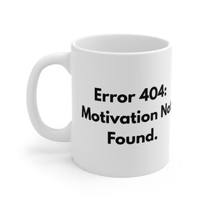 May include: White ceramic coffee mug with a curved handle. The mug features the text "Error 404: Motivation Not Found" in black, bold font. The mug is designed for hot beverages and is suitable for home or office use.