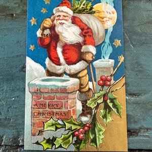 Antica cartolina di Natale in rilievo del 1908 Babbo Natale con camino e uomo sulla luna