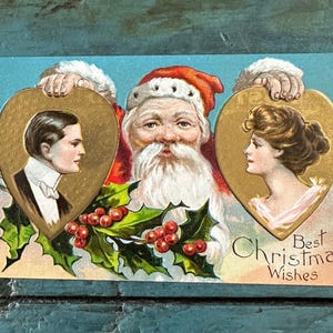 Cartão postal antigo de Bamforth com o coração de Natal em relevo, Papai Noel