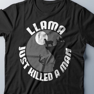 May include: Black t-shirt with a white circle graphic. The graphic features a silhouette of a man falling from a cliff with two llamas standing on top. The text "Llama Just Killed A Man" is written around the circle.