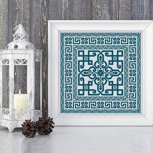 May include: A framed cross-stitch pattern with a teal blue geometric design. The design features a central square with a repeating pattern of interlocking shapes. The square is surrounded by a border of smaller squares and a repeating pattern of Greek key designs.