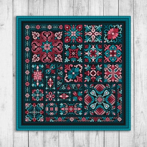 May include: A teal blue square frame with a black background and a colourful geometric pattern of pink, teal, and white. The pattern is made up of repeating squares and rectangles.