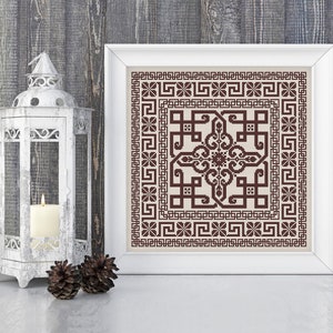 May include: A framed cross-stitch embroidery with a brown geometric pattern on a beige background. The frame is white and the embroidery is in a square shape.