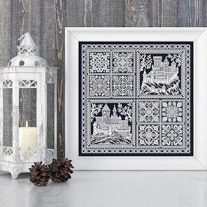 May include: A framed cross-stitch embroidery featuring a white castle design on a dark blue background. The design is divided into nine squares, with the castle in the centre and various geometric patterns in the surrounding squares.