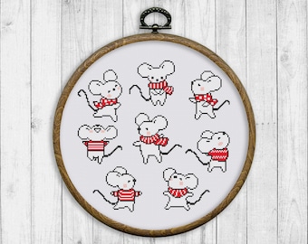 May include: Embroidered hoop art featuring eight white mice wearing red scarves. The mice are in various poses, some with their tails curled up.