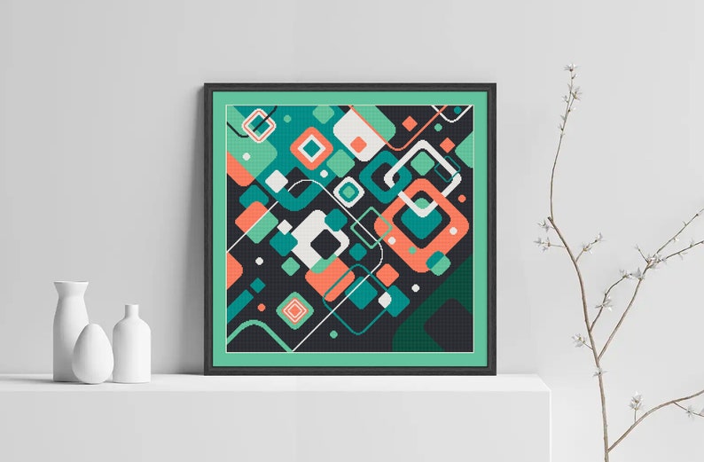 Pode incluir: Impress&atilde;o de arte geom&eacute;trica abstrata com fundo preto e formas coloridas em tons de verde, azul, laranja e branco. A impress&atilde;o &eacute; emoldurada em uma moldura preta com um passe-partout verde.