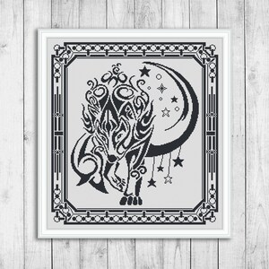 May include: Black and white cross stitch pattern of a stylized wolf howling at the moon with stars in the background. The pattern is framed in a black and white border.