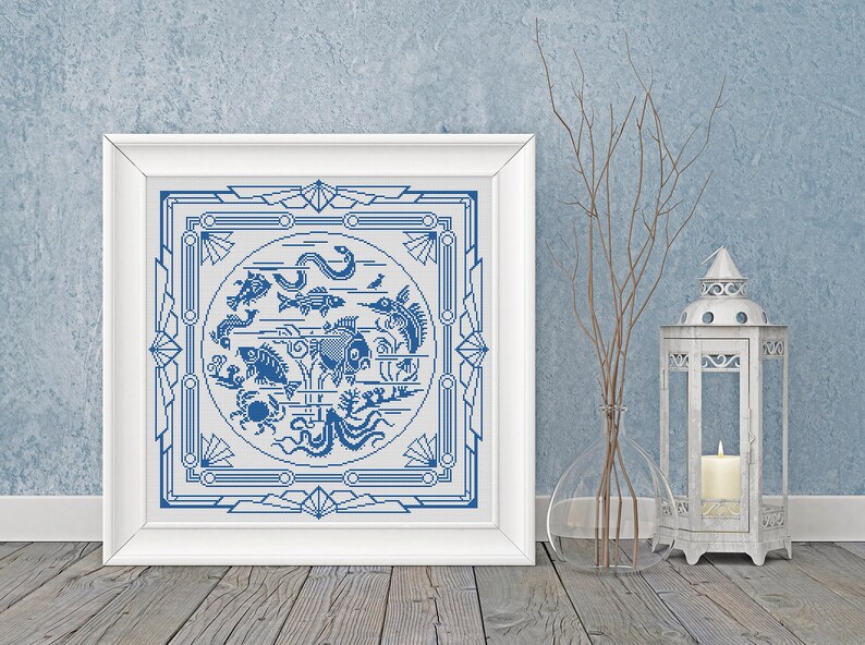 May include: A white framed picture with a blue and white design of various sea creatures inside a decorative frame. The design is reminiscent of a vintage tile.