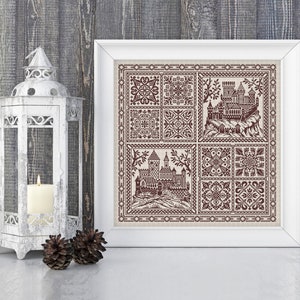 May include: A framed cross-stitch embroidery featuring a brown castle design with a repeating pattern of geometric shapes. The embroidery is on a cream-coloured fabric and is framed in a white frame.