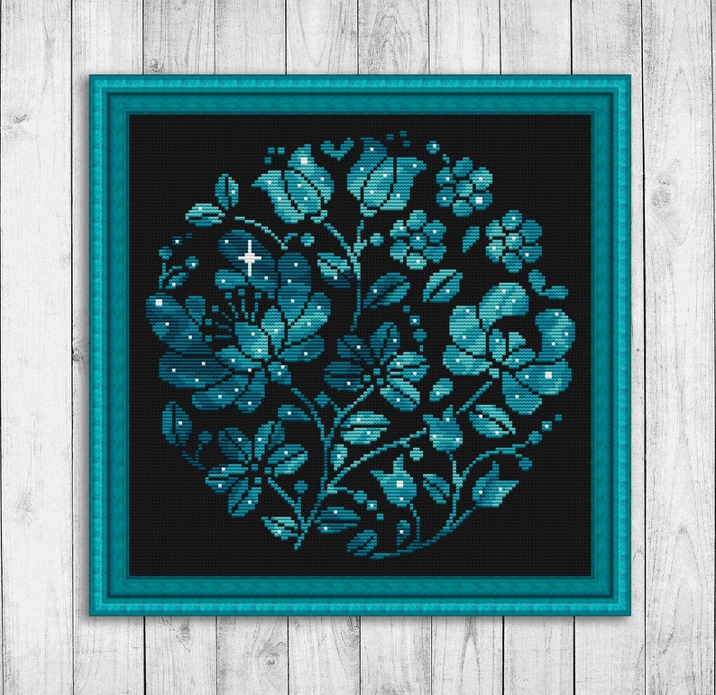 May include: A teal blue floral design with white accents on a black background. The design is framed in a teal blue frame.