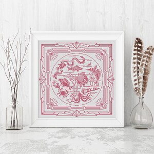 May include: A framed cross-stitch design featuring a pink and white geometric pattern with a circle in the center. The circle contains a variety of pink fish, sea creatures, and plants.