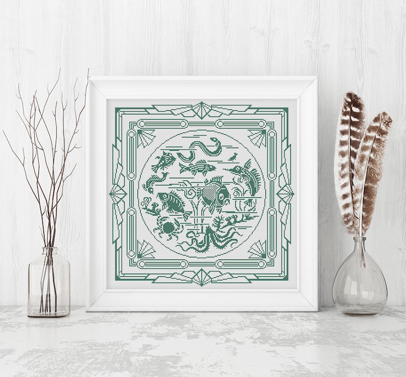 May include: A framed cross-stitch design featuring a green and white geometric pattern with a circle in the center. The circle contains a variety of sea creatures, including fish, a crab, a seahorse, and an octopus.