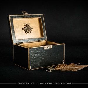 Black treasure box with a golden bee - an elegant gift for a woman