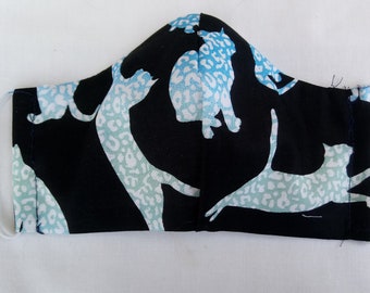May include: Black face mask with a pattern of white and blue leopard print cats.