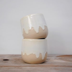 Cup with drippy white glaze. 250 ml