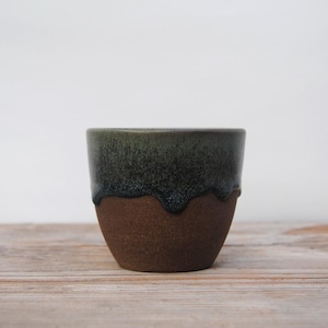 Cup with drippy dark blue/green glaze. 200 ml