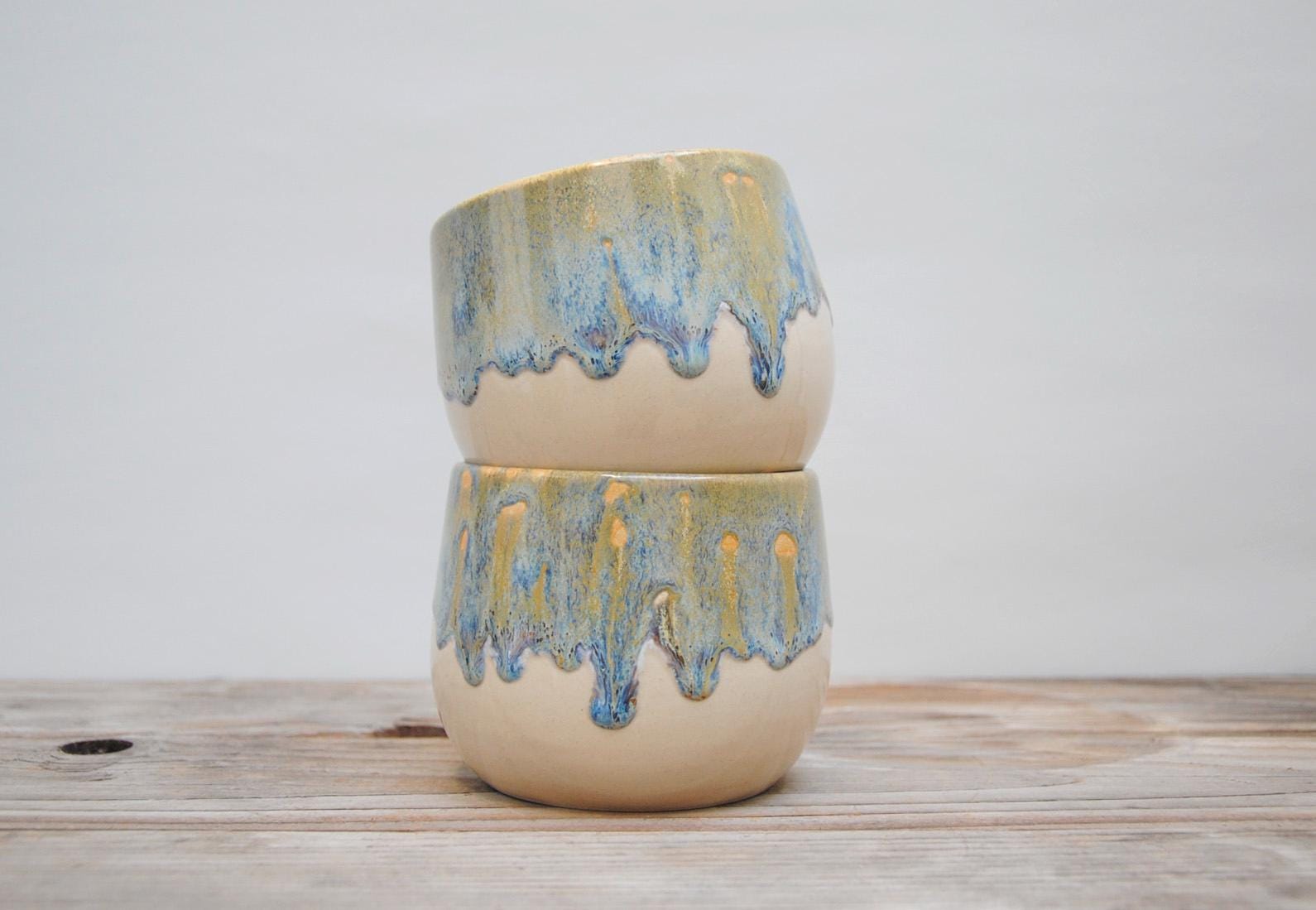 Cup with drippy textured orange/blue glaze. 400ml