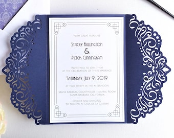 May include: Navy blue wedding invitation with a laser cut design. The invitation is folded in thirds and features the names "Stacey Bullington & Peter Cunningham" and the date "Saturday, July 9, 2019".