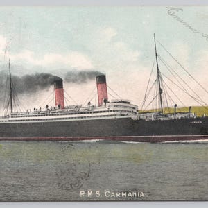 May include: Vintage postcard featuring the R.M.S. Carmania, a large ocean liner, sailing on the water. The ship is black with a red waterline and two smokestacks with red tops. The postcard has handwritten text and the date February 17, 1906.