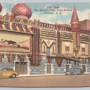 May include: Vintage postcard featuring the World's Only Corn Palace in Mitchell, South Dakota. The building has a unique design with decorative elements and colorful accents. The image includes classic cars parked in front of the building.