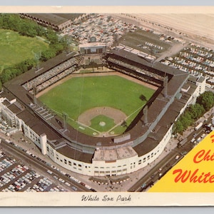 May include: Vintage postcard featuring an aerial view of White Sox Park, the home of the Chicago White Sox. The baseball stadium is surrounded by parking lots and green spaces. Text on the postcard reads "Home of Chicago White Sox" and "White Sox Park."