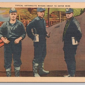 May include: A vintage postcard showing three anthracite miners in dark work clothes and caps, ready to enter a mine. The text at the top reads "TYPICAL ANTHRACITE MINERS ABOUT TO ENTER MINE." The postcard has a sepia tone.