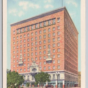 May include: Vintage postcard of the Hotel Cortez in El Paso, Texas. The multi-story brick building features numerous windows, decorative elements, and an American flag on the roof. The text "Air-Conditioned Guest Rooms" is at the top.