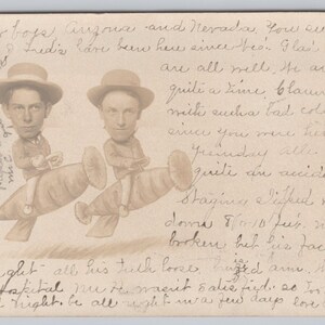 May include: Sepia-toned postcard featuring two caricatures of men riding whimsical, elongated objects. Both men wear hats and are depicted with exaggerated facial features. Handwritten text fills the card, suggesting a personal message.
