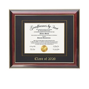 May include: A rectangular diploma frame with a dark mahogany wood finish, featuring a black mat with gold trim. The document displays the text Gradframes by 3art, Jessica Smith, Business Administration, and Class of 2026 with a gold seal.