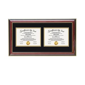 May include: A rectangular double document frame with a polished mahogany-colored wood finish and a black mat board. The frame features two white document inserts with gold-colored borders and gold circular seals, each displaying the text Gradframes by 3art.