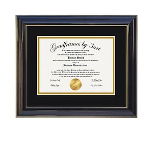 May include: A black wooden diploma frame with a black mat and gold inner trim. The document inside reads Gradframes by Sart, Jessica Smith, and Business Administration, featuring a gold circular seal at the bottom center of the white paper.