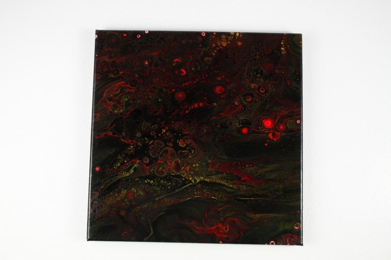 May include: Abstract painting on canvas with swirling patterns in shades of black, red, and green. The painting features a variety of small, round shapes in red and gold.
