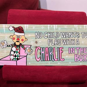 Hand painted Island of Misfit Toys “Charlie in a Box” Christmas sign