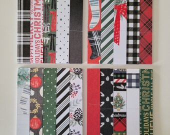 May include: Set of 12 decorative paper strips with various Christmas-themed patterns, including plaid, stripes, snowflakes, and a stocking. The strips are black, white, red, and green.